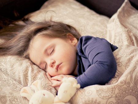 Girl toddler sleeping in a bed