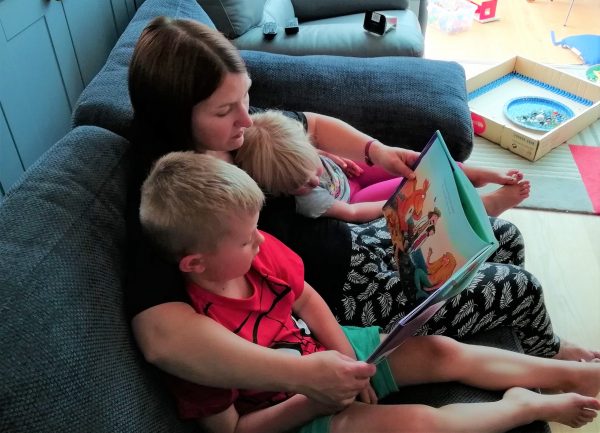 Mum and children sharing a book