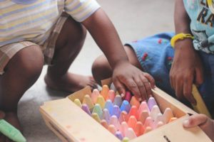 Children playing with chunky chalks