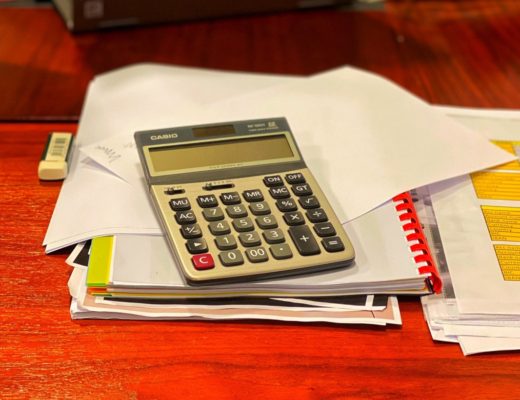 Calculator on pile of papers